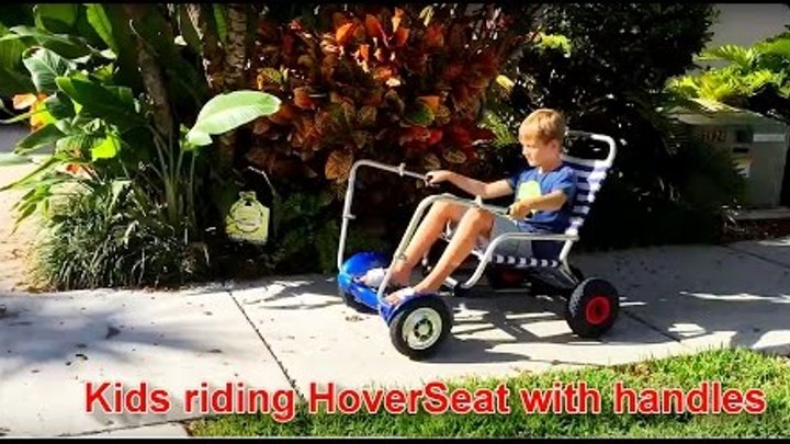 Kids riding HoverSeat with handles.